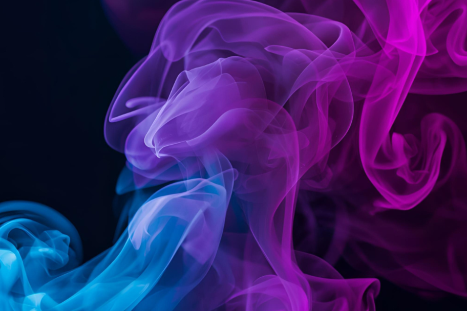 Colorful smoke or ink swirling on a black background